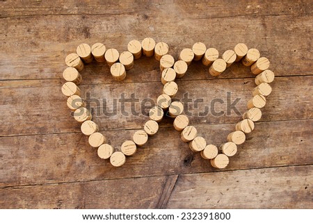 Wine corks form a heart shape on the wood board