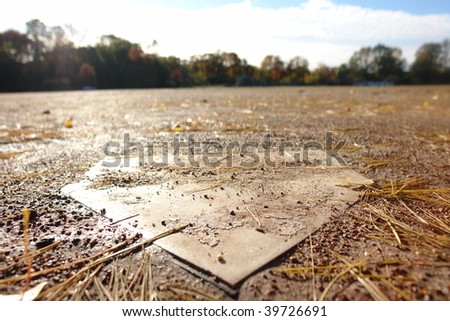 Home plate in the empty baseball ground after storm