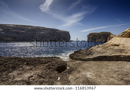 Malta Island, Gozo, Dweira Lagoon, view of sailing boats and the rocky coastline near the Azure Window Rock