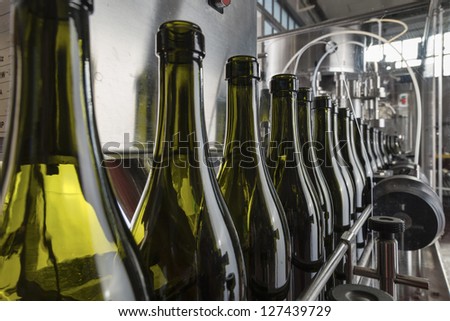 Italy, Sicily, wine bottles ready to be washed and filled with wine by an industrial machine in a wine factory