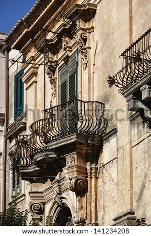 Italy, Sicily, Ragusa Ibla, Baroque building, old balcony with baroque ornaments.