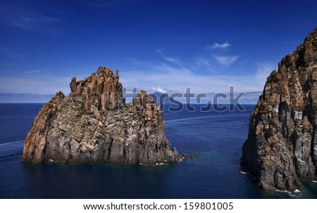 Italy, Sicily, Aeolian Islands, Panarea Island, Basiluzzo Rock (Stromboli Island in the background), aerial view