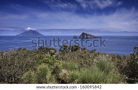 Italy, Sicily, Aeolian Islands, Panarea isl., Basiluzzo Rock (Stromboli island in the background)