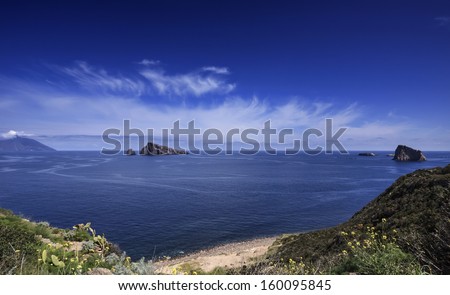 Italy, Sicily, Aeolian Islands, Panarea isl., view of Basiluzzo Rock (Stromboli island in the background)