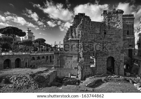 Italy, Rome, Roman Forum (Forum of Nerva, 97 A.D), roman ruins. The Victorian Palace in the background