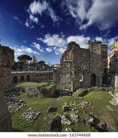 Italy, Rome, Roman Forum (Forum of Nerva, 97 A.D), roman ruins. The Victorian Palace in the background