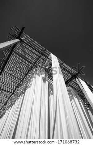 India, Rajasthan, Jaipur, indian man hanging cotton clothes to dry under the sun