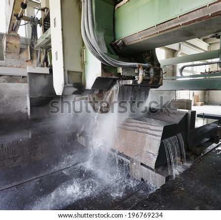 Italy, marble cutting factory, marble being cooled with water while cut - industrial