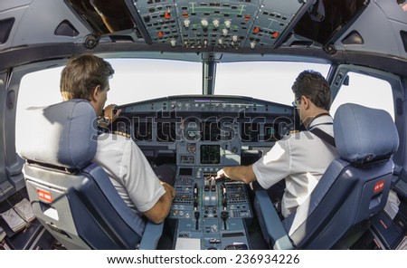 Pilots in an airplane cockpit