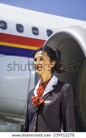 Italy, flight stewardess near an airplane