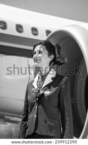 Italy, flight stewardess near an airplane