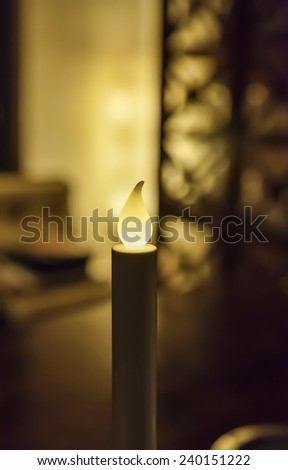 Electric candle in the living room of a private house