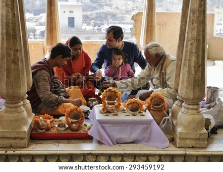 India, Rajasthan, Jaipur; 25 january 2007, indian family in a hindu temple near Sisodia Rani Ka Bagh Palace - EDITORIAL