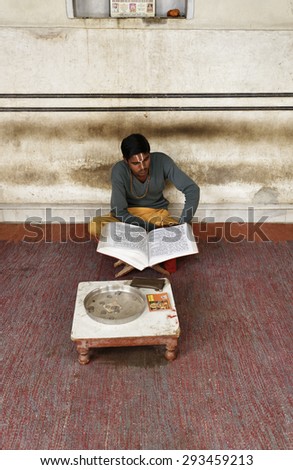 India, Rajasthan, Jaipur; 25 january 2007, indian boy reading a religious book in a hindu temple near Sisodia Rani Ka Bagh Palace - EDITORIAL