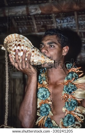 Fiji Islands, Lautoka; 28 january 2001, man in traditional fijian outfit blows in a sea shell - EDITORIAL (FILM SCAN)