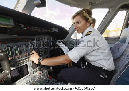 Italy, female pilot in an airplane\'s cockpit