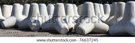 Italy, Sicily, Messina province, concrete tetrapods on the beach near a port under construction