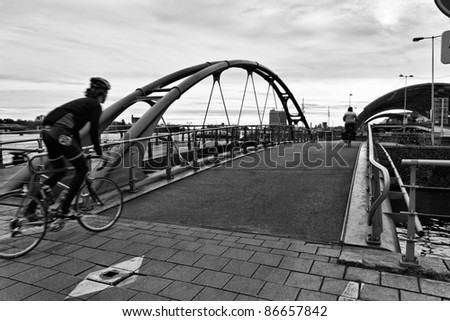 Holland, Amsterdam, bikers on a bridge near the Central Station
