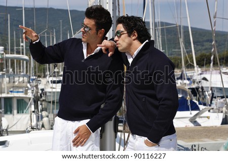 Italy, Tuscany, young sailors dressed casual on a sailing boat
