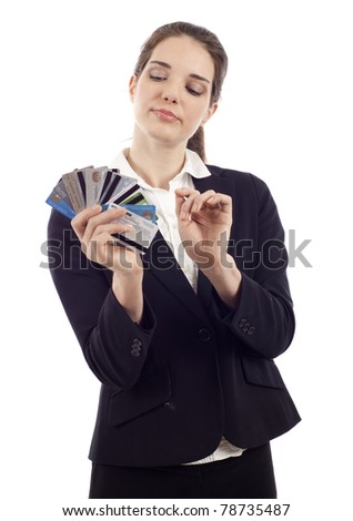 Beautiful young woman choosing which credit card to pay with, isolated over white