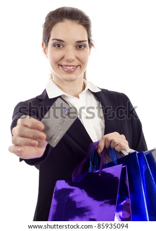 Happy young businesswoman holding credit card with shopping bags isolated over white