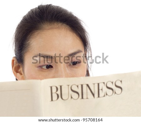 Closeup of an Asian woman reading a business newspaper isolated over white background