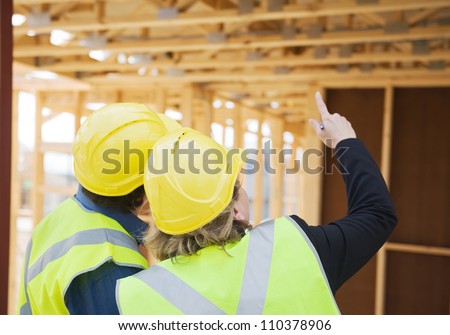 civil engineer and worker discussing issues at the construction site