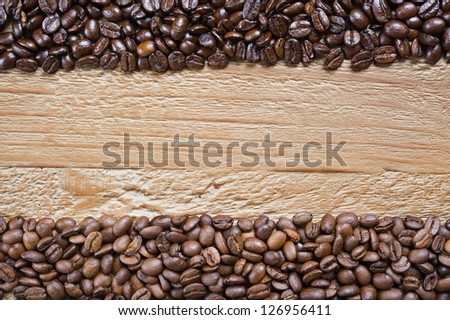 coffee beans background from two different kind of coffee on the old wooden table