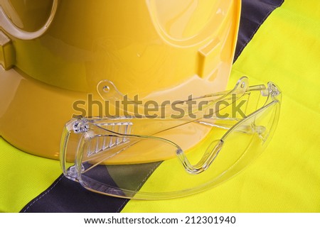 Yellow vest and helmet with protection glasses
