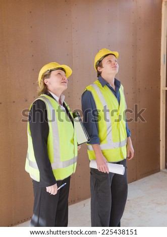 civil engineer and worker discussing issues at the construction site