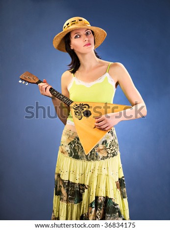 pretty woman with a national russian a stringed instrument in her hands