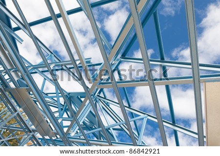 New residential construction home metal framing against a blue sky