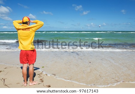 young man  life saver  watching the situation on the sea
