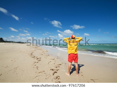 young man  life saver  watching the situation on the sea