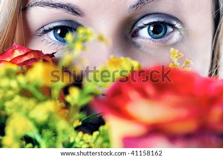Girl and roses : Beautiful young woman\'s face fragment with colour roses over.