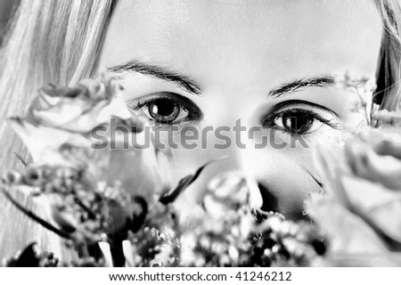 Girl and roses : Beautiful young woman\'s face fragment with colour roses over (Black and White).