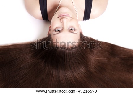Beautiful woman with gorgeous dark hair. Upside down. Isolated on white.