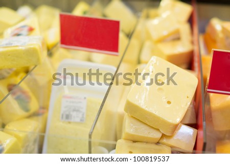Variety of cheese pieces in supermarket