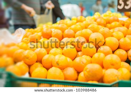 Variety of oranges on boxes in supermarket