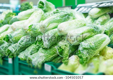 Variety of Chinese cabbages in boxes in supermarket