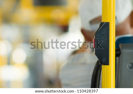 Stop button on yellow holder in modern bus