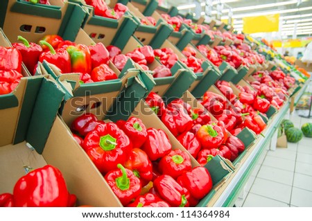 Red paprika peppers in boxes in supermarket
