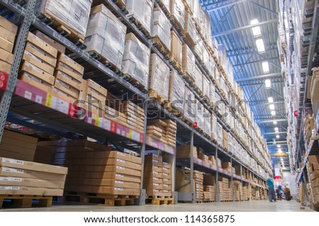 Rows Of Shelves With Boxes In Modern Warehouse