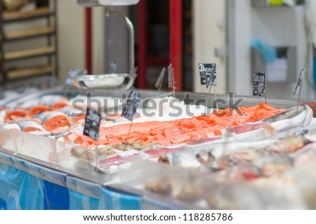 Fresh atlantic salmon lie on table with ice in supermarket