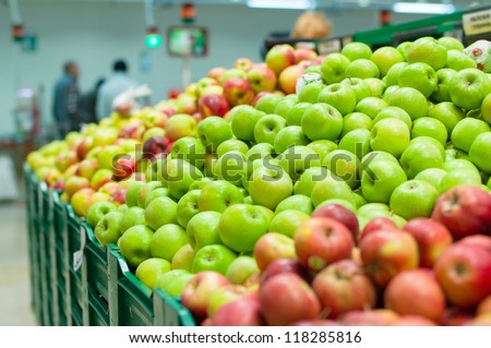Bunch of red and green  apples on boxes in supermarket