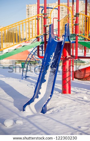 Kids huge slide on winter playground covered with snow
