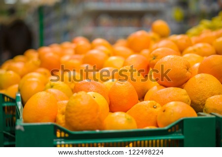 Bunch of oranges in boxes in supermarket