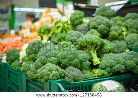 Bunch of broccoli cabbages on boxes in supermarket