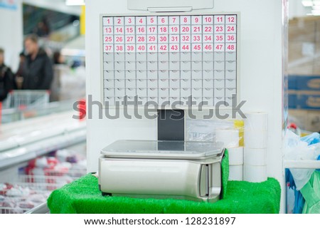 Electronic weighting machine with numbered keypads in supermarket