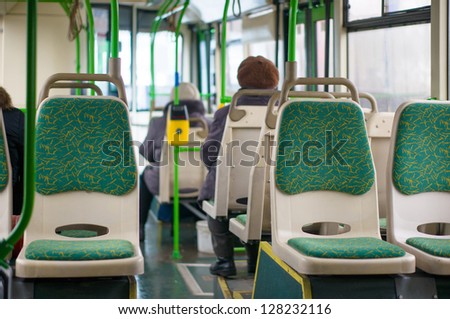 Interior of modern articulated bus. Seat places in front side of bus